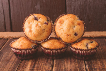 Muffins on wooden background on rustic style. Cupcake with currant