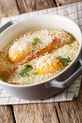Italian baked bread soup alla Pawese close-up. vertical