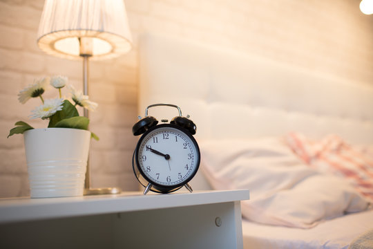 An alarm clock near the bed