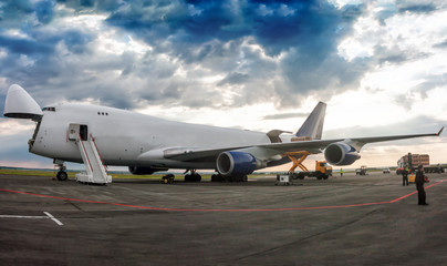 Fototapeta na wymiar Unloading wide body cargo airplane