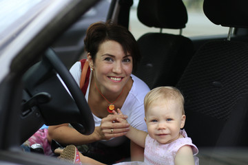 Small cute baby and mom in a car