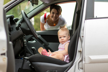 Small cute baby and mom in a car