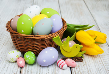 Basket with easter eggs and tulips