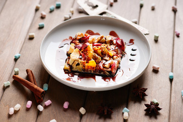 A piece of sliced fruit pie, sugar cubes and metal paddle 