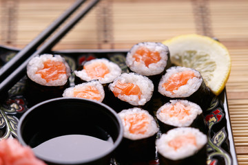 Sushi rolls with salmon, soy sauce and chopsticks 