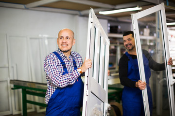 workmen with PVC profiles and windows