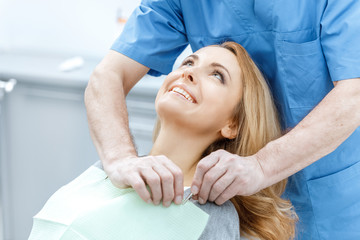 Obraz na płótnie Canvas beautiful smiling woman in dental clinic with dentist doctor