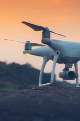 drone quad copter with digital camera at sunset ready to fly for surveillance
