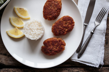 Overhead view of fish croquettes with fresh green salad.