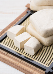 Fresh tofu isolated on wood background