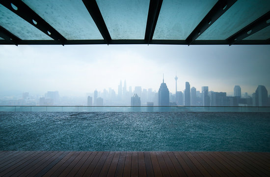 Swimming pool on roof top with beautiful city skylinr view,raining.day , kuala lumpur malaysia.
