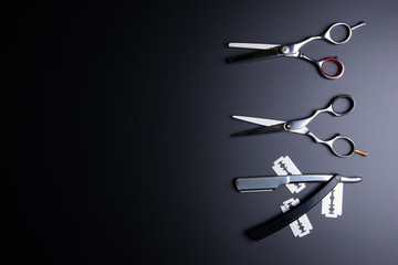 Razor, Stylish Professional Barber Scissors, Hair Cutting on black background. Hairdresser salon concept, Hairdressing Set. Haircut accessories. Copy space image, flat lay.