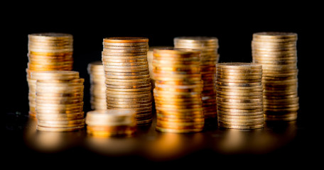 Stack of golden coins isolated on black background