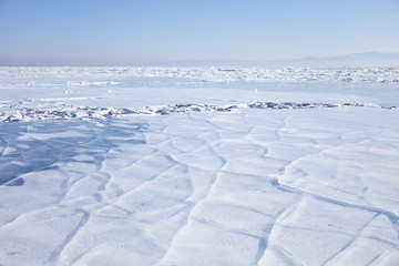 Lake Baikal, cracks in ice. Winter landscape