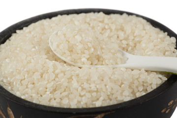Rice in wooden bowl. Uncooked rice grains