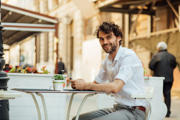 handsome elegant man sitting outside ar terrace