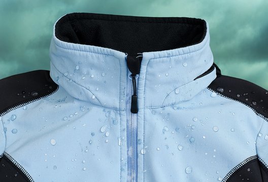 Softshell jacket  with rain drops. Cloudy sky in the background.