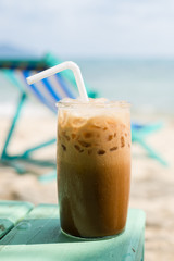 Enjoying an iced coffee on the beach