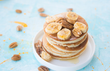 The American pancakes with honey, bananas and nuts
