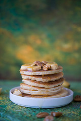 The American pancakes with honey, bananas and nuts
