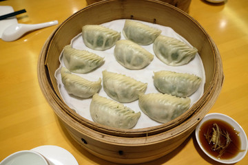 Chinese steamed dumpling in Bamboo Steamer, commonly eaten in East Asia in Beijing, China