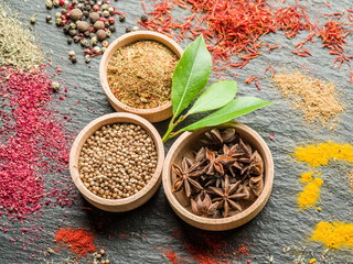 Assortment of colorful spices on the graphite background.