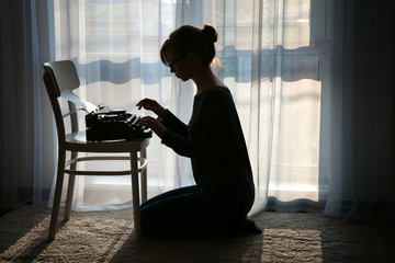 Girl typing on a typewriter