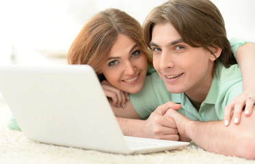 Beautiful young couple with a laptop
