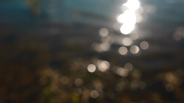 Backgraound of sparkles and ripple on the water out of focus.