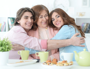 Happy family drinking tea together