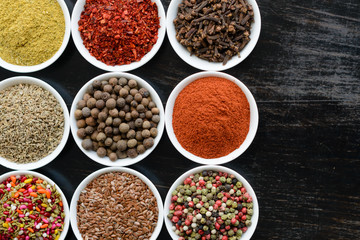 Various spices on wooden spoons. Food ingredients