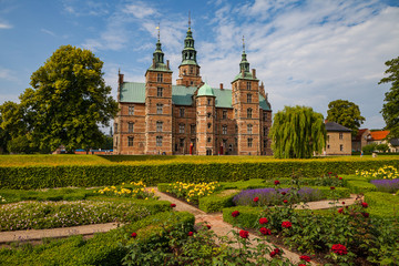 Rosenborg castle, Copenhagen. Sunny summer day view. Blooming terraces at the foreground.