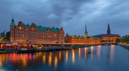 Fototapeta premium Night panoramic view on Christiansborg Palace and Slotsholmen over the canal in Copenhagen, Denmark.
