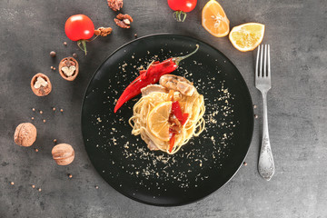Delicious chicken spaghetti with pepper and lemon on plate
