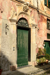 Fototapeta na wymiar sunny entrance portal, Finalborgo, Italy