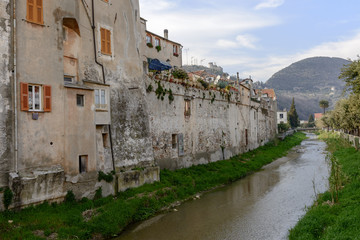 Fototapeta na wymiar village walls and Aquila creek, Finalborgo, Italy