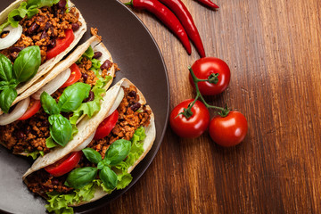 Mexican tacos with minced meat, beans and spices