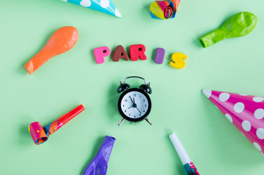 photo of colorful letters, alarm clock and birthday decorations on the wonderful green background