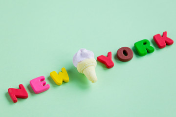 photo of ice cream marshmallow and colorful letters on the wonderful green background