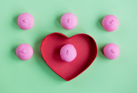 photo of tasty pink marshmallows and heart shaped box on the wonderful green studio background