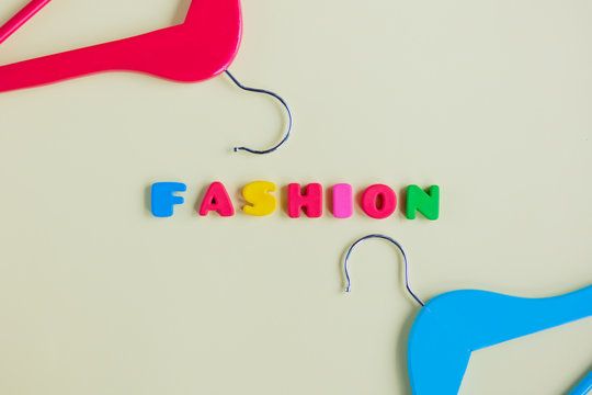 photo of wooden hangers and colorful letters on the wonderful yellow background