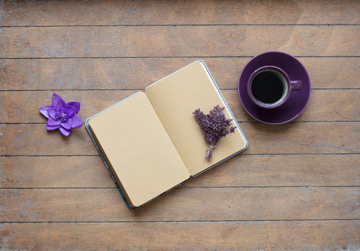 photo of opened notebook, bunch of lavender, purple flower and cup of coffee on the wonderful wooden brown background