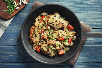 Tasty chicken marsala on pan on table