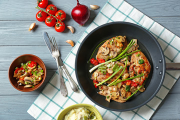 Tasty chicken marsala with vegetables on table