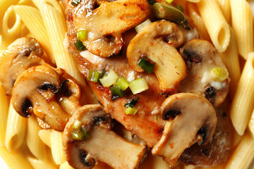 Tasty chicken marsala with pasta, close up