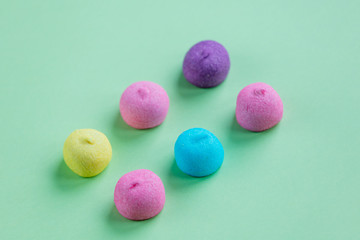 Fototapeta na wymiar photo of tasty colorful marshmallows on the wonderful green studio background