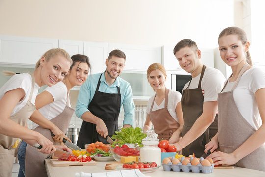 Male chef and group of people at cooking classes