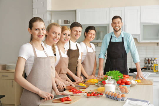 Male chef and group of people at cooking classes