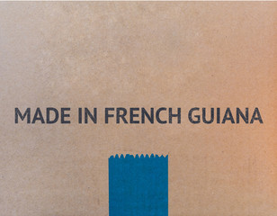 MADE IN FRENCH GUIANA written on brown cardboard box with copy-space for your text.