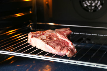 Raw steak in oven
